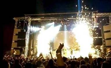 A crowd of people in front of a stage with lights

Description automatically generated with medium confidence